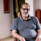 Portrait of old man sitting on chair at home